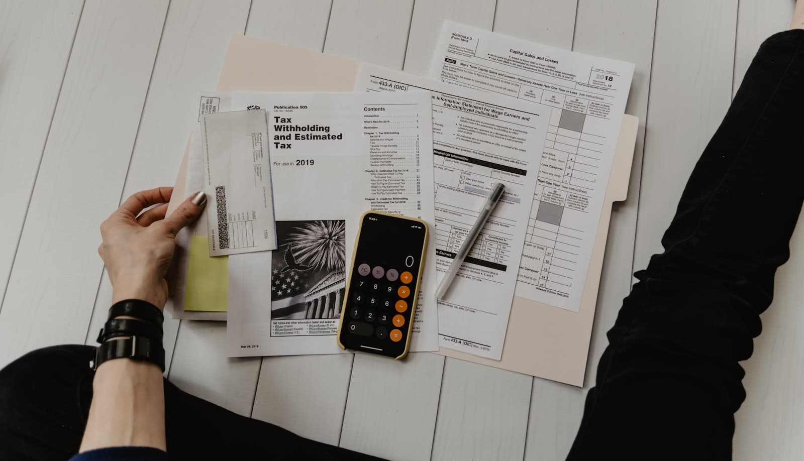 Calculator, glasses, and financial paperwork on an accounting desk